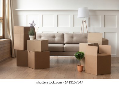 Moving day concept, cardboard carton boxes stack with household belongings in modern house living room, packed containers on floor in new home, relocation, renovation, removals and delivery service