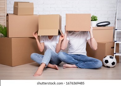 Moving Day - Funny Young Couple Covering Their Faces With Cardboard Boxes