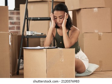 Moving Deserves A Vacation. Shot Of A Young Woman Having A Stressful Day During Packing At Home.