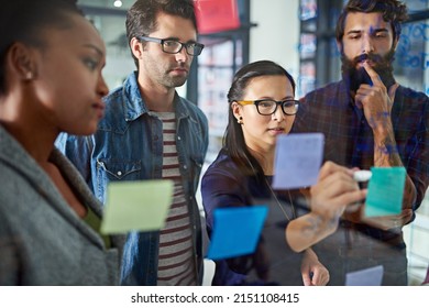 Moving Forward Together As A Team. Cropped Shot Of Coworkers Brainstorming In A Modern Office.