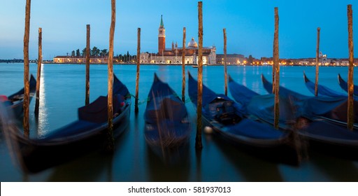 Moving Gondolas on Venice waterfront, San Giorgio Maggiore on the background