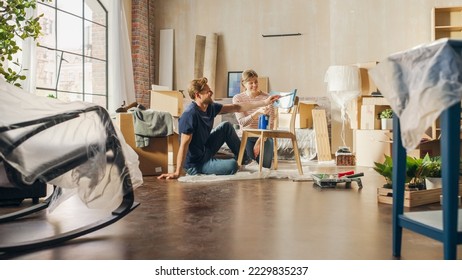 Moving in   Home Renovations: Couple in Love Painting Vintage Furniture Chair for New Cozy Home  Cheerful Young Family Make Apartment Comfortable and Art  Color  Smiles   Happiness