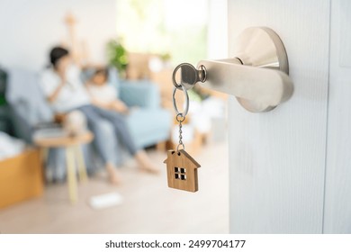 Moving house, relocation. Family smile and happy after buy new apartment, inside the room was a cardboard box contain personal belongings and furniture. move in the new apartment or condominium