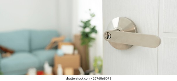 Moving house, relocation. The key was inserted into the door of the new house, inside the room was a cardboard box containing personal belongings and furniture. move in the apartment or condominium