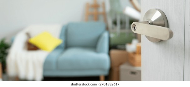 Moving house, relocation. The key was inserted into the door of the new house, inside the room was a cardboard box containing personal belongings and furniture. move in the apartment or condominium