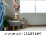 Moving house, relocation. Man hold key house keychain in new apartment. move in new home. Buy or rent real estate. flat tenancy, leasehold property, new landlord, investment, dwelling, loan, mortgage.