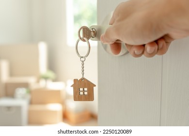 Moving house, relocation. Man open new room in new apartment, inside the room was a cardboard box containing personal belongings and furniture. move in the apartment or condominium - Shutterstock ID 2250120089