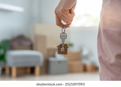 Moving house, relocation. Woman hold key house keychain in new apartment. move in new home. Buy or rent real estate. flat tenancy, leasehold property, new landlord, dwelling, loan, mortgage.
 - Powered by Shutterstock