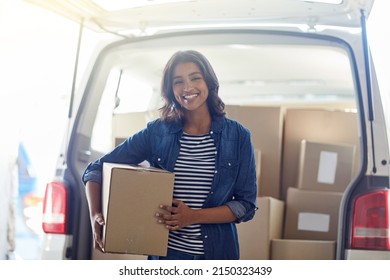 Moving On To Bigger And Better Things. Portrait Of An Attractive Young Woman Unpacking Boxes From The Trunk Of Her Car.