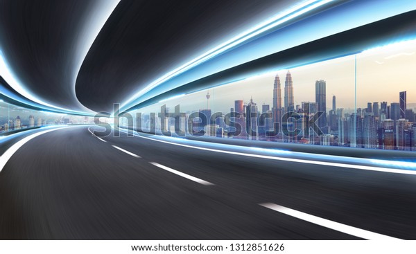 Moving on tunnel with transparent glass window and\
modern city skyline view\
.
