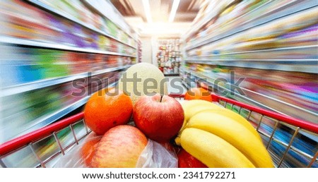Moving shopping cart in supermarket, shot with slow shutter from the shopper's point of view