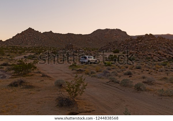 Moving through Mojave Desert in\
California by car. At dusk before a winter sunset in\
desert.