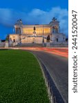 Moving traffic around Piazza Venezia with the Victor Emmanuel Monument at night, Rome, Lazio, Italy, Europe