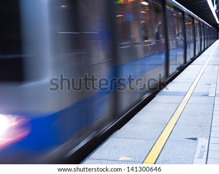 Moving train in subway station