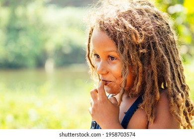 Mowgli indian boy with dreadlocks hair in tropics green forest background