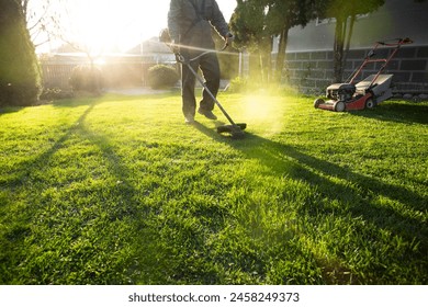 Mowing the grass with a lawn mower. Garden work concept background. - Powered by Shutterstock