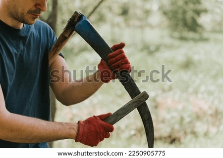 Image, Stock Photo Scythes; a man with a scythe in the garden.