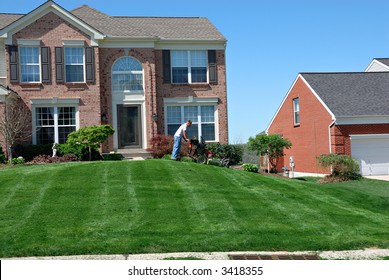 Mowing The Lawn - Professional Lawn Care Service Using A Riding Lawn Mower To Cut The Grass.