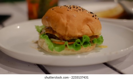 Moza beef burger served at the restaurant. American food style. Delicious gourmet on a wooden table.

 - Shutterstock ID 2233137431