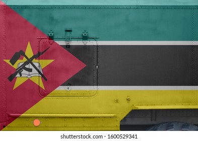 Mozambique Flag Depicted On Side Part Of Military Armored Truck Closeup. Army Forces Conceptual Background