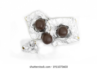 Mozartkugel Closed Up Wrapped Into Foil , Chocolate Pralines Isolated On White.