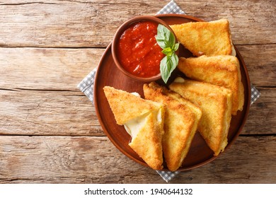 Mozzarella in carrozza is made of sliced bread enclosing the precious creaminess of the mozzarella closeup in the plate on the table. horizontal top view from above - Powered by Shutterstock