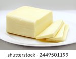 MOZZARELLA CHEESE BAR WITH SLICES ON DISH ISOLATED ON WHITE BACKGROUND