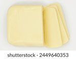 MOZZARELLA CHEESE BAR VIEW FROM TOP WITH SLICES ON PLATE ISOLATED ON WHITE BACKGROUND