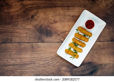 Mozzarella Cheese Sticks On A Wooden Table With Room For Copy