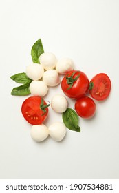 Mozzarella Cheese, Tomato And Basil On White Background