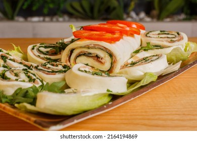 Mozzarella roll stuffed with rocket and raw ham served for lunch in a rotisserie