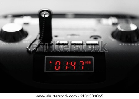 MP3 player panel with digital indicator. Dark key with shallow depth of field in backlight