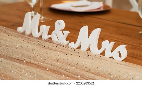 Mr And Mrs Sign Close Up On A Wedding Table Set For The Newlyweds.