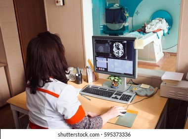 MRI machine and screens with doctor and nurse - Shutterstock ID 595373336