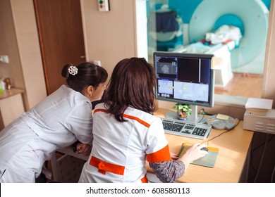 MRI Machine And Screens With Doctor And Nurse