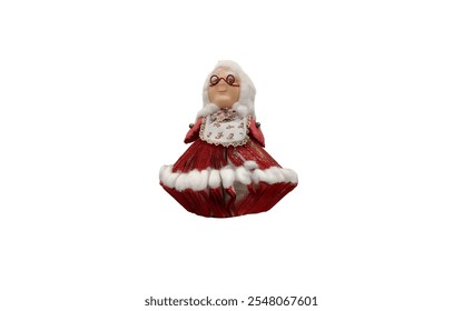 A Mrs. Claus figurine. She is wearing a red dress with white fur trim, a white apron, and glasses. She has white hair and a smiling face. - Powered by Shutterstock