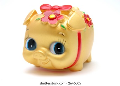 Ms piggy bank in golden color, isolated white