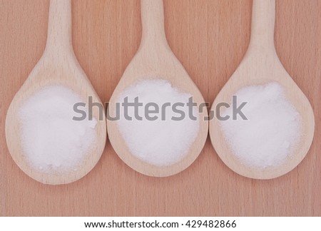 MSM pure powder in 3 wooden spoons.