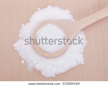 MSM pure powder in wooden spoon. It occurs naturally in some primitive plants, is present in small amounts in many foods and beverages and is marketed as a dietary supplement.