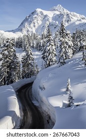 Mt Baker Road Gap With Two Jumps Built and Mt Shuksan Towering in the Blue Sky Background