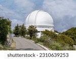 Mt Hamilton, CA, USA - May 28, 2023: Road leading to Shane telescope, and building housing the telescope, part of the Lick Observatory