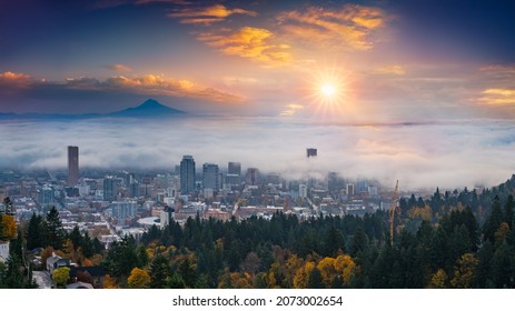 Mt. Hood and Portland downtown with rolling fog and autumn foliage in shining sunrise and colorful clouds