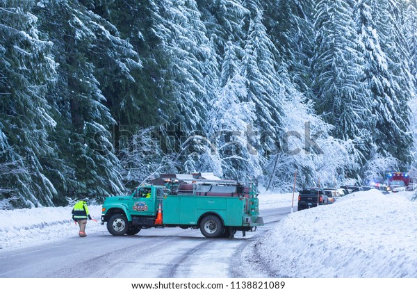Mt Hood, OR /\
USA - December 30 2016: Emergency vehicles block frozen road at the\
Santiam pass due to\
accident.
