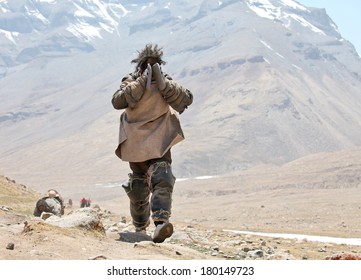 Mt Kailash, Tibet, China - May 26, 2012: Buddhist pilgrim making the kora (circumambulation) around Mt. Kailash and performing full body prostrations