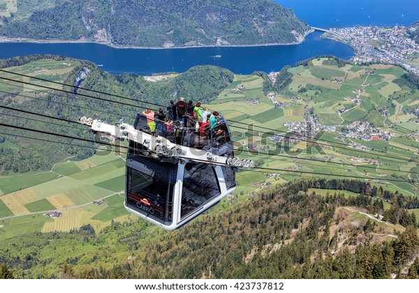 Mt. Stanserhorn,\
Switzerland - 7 May, 2016: people in a gondola of the Stanserhorn\
Cabrio cable car. Stanserhorn Cabrio is the the world\'s first\
double deck open top cable\
car.