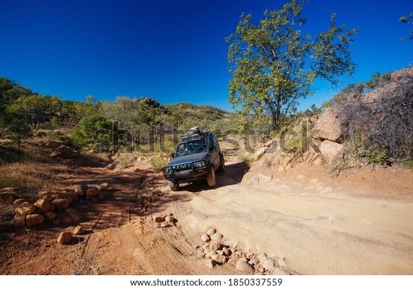 Mt Surprise, Australia - July 6, 2016: A 4WD\
car negotiating a rural track in the outback near Mt Surprise,\
Queensland, Australia