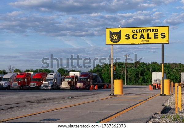 Mt. Vernon, Missouri - June, 12 2019 - CAT\
scale. Sertified Truck and Trailer Scale. Modern trucks of various\
models  transportation of different kinds of commercial goods stand\
on truck stop parking.