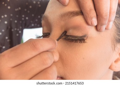 MUA adding makeup on the upper eyelid. Professional makeup techniques.