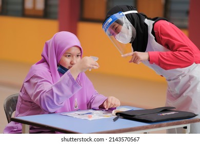 Muadzam Shah, Malaysia - April 7th, 2022 : Lateral-Flow-Test Covid Rapid Home-use Test Kit For Saliva - Step 2 - Spit With Mouth Through Funnel In Plastic Tube To Collect Sample.