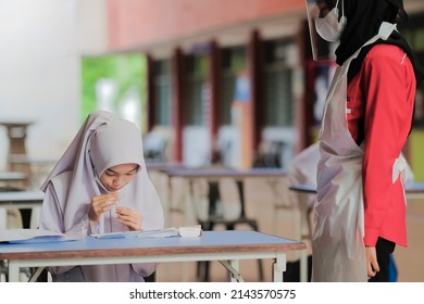 Muadzam Shah, Malaysia - April 7th, 2022 : Lateral-Flow-Test Covid Rapid Home-use Test Kit For Saliva - Step 2 - Spit With Mouth Through Funnel In Plastic Tube To Collect Sample.